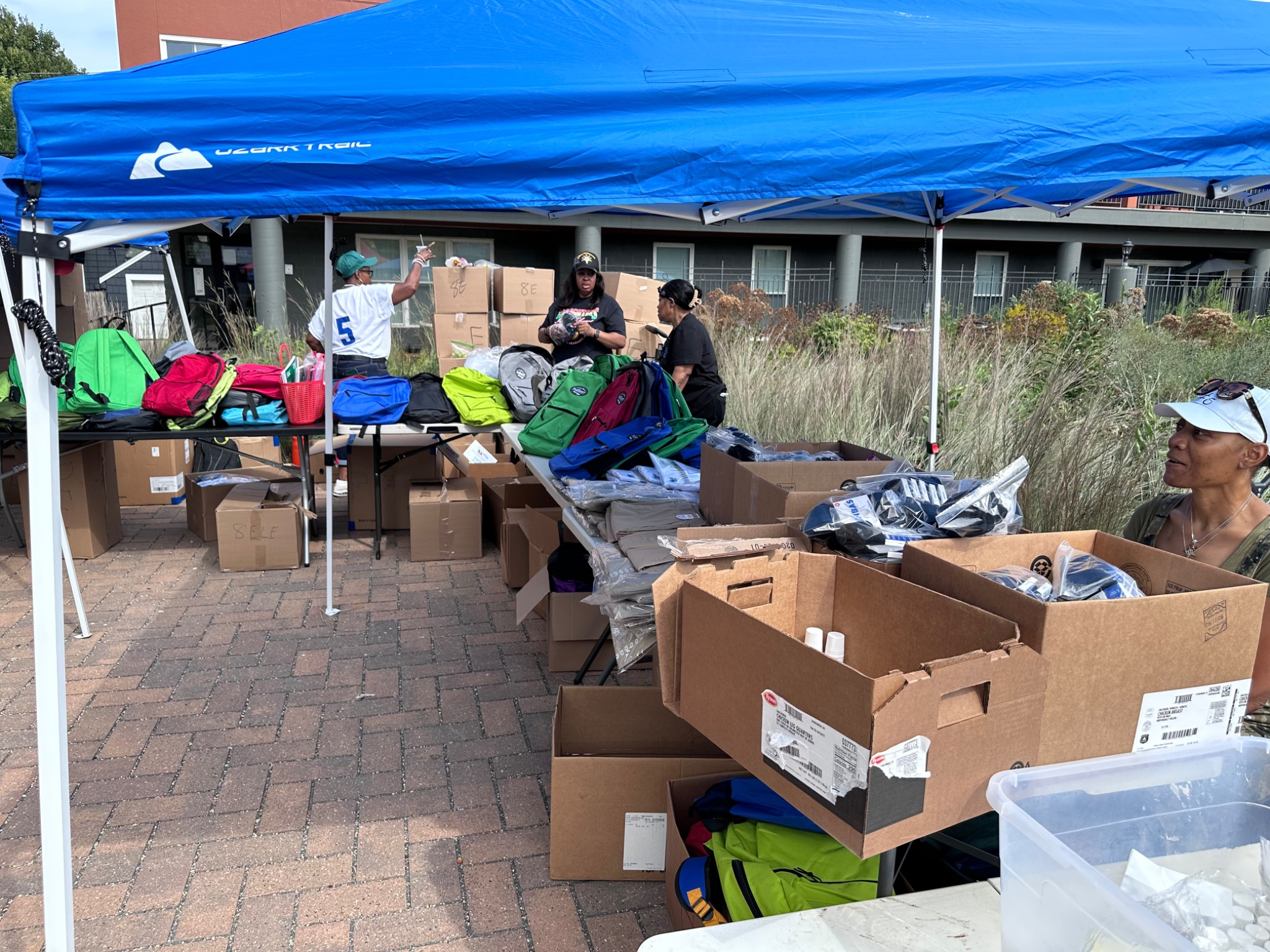 Volunteers organizing backpacks and school supplies at the Fresh and Fly Bash