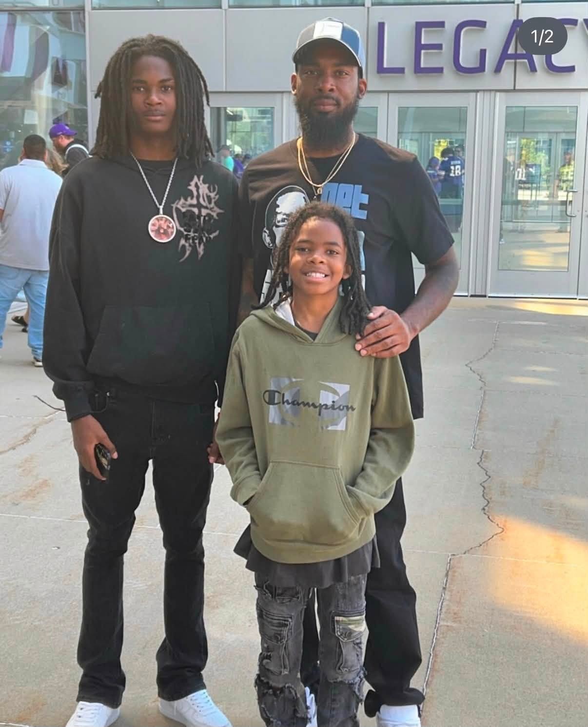 DJ with family members outside a sports venue at the Fresh and Fly Bash